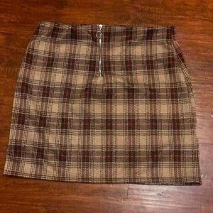 I’m selling a plaid skirt it goes a little over the knees perfect with anything